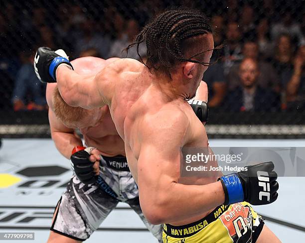 Tatsuya Kawajiri of Japan throws a back fist against Dennis Siver of Germany in their featherweight bout during the UFC Fight Night event at the O2...