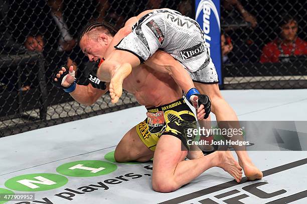 Dennis Siver of Germany lunges at Tatsuya Kawajiri of Japan in their featherweight bout during the UFC Fight Night event at the O2 World on June 20,...