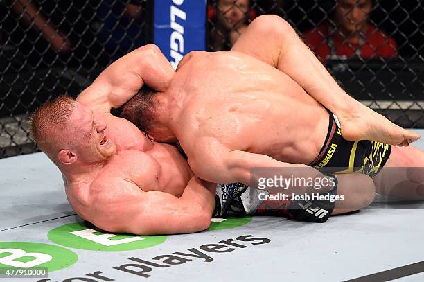 Dennis Siver of Germany attempts a submission against Tatsuya Kawajiri of Japan in their featherweight bout during the UFC Fight Night event at the...