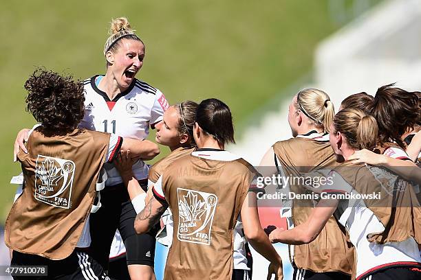 Anja Mittag of Germany celebrates with team mates as she scores the opening goal during the FIFA Women's World Cup Canada 2015 Round of 16 match...