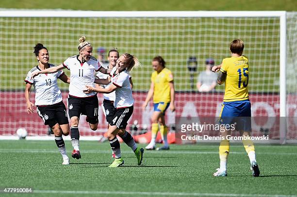 Anja Mittag of Germany celebrates with team mates as she scores the opening goal during the FIFA Women's World Cup Canada 2015 Round of 16 match...