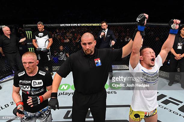 Tatsuya Kawajiri of Japan celebrates after defeating Dennis Siver in their featherweight bout during the UFC Fight Night event at the O2 World on...