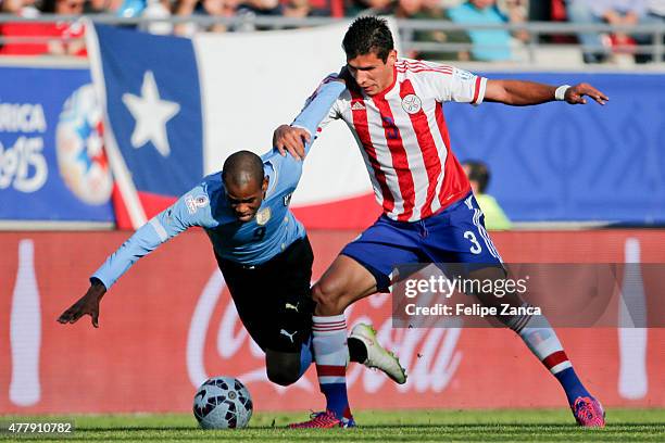 Diego Rolan of Uruguay fights for the ball with Marcos Caceres of Paraguay during the 2015 Copa America Chile Group B match between Uruguay and...