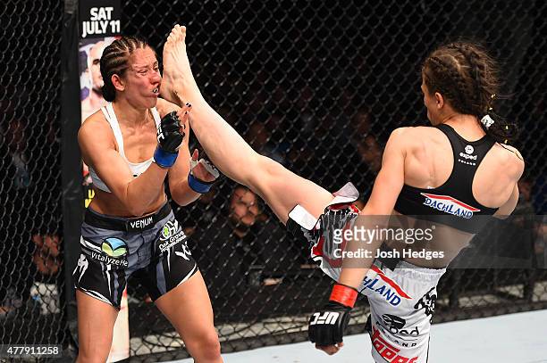 Joanna Jedrzejczyk of Poland lands a front kick against Jessica Penne of the United States in their women's strawweight championship bout during the...