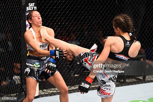 Joanna Jedrzejczyk of Poland lands a front kick against Jessica Penne of the United States in their women's strawweight championship bout during the...