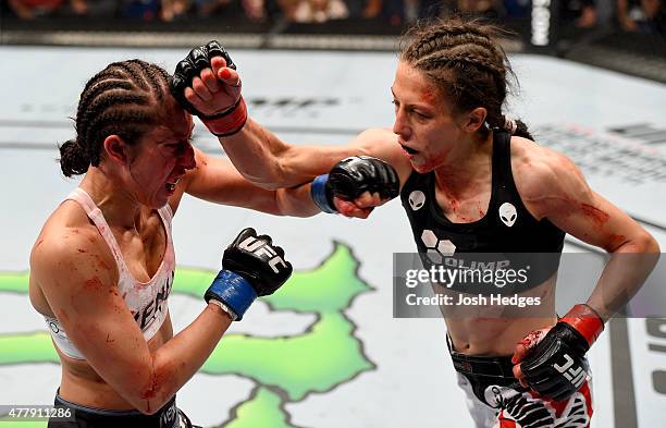 Joanna Jedrzejczyk of Poland punches Jessica Penne of the United States in their women's strawweight championship bout during the UFC Fight Night...