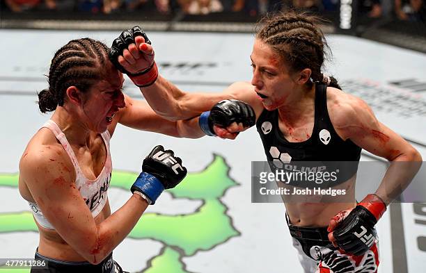Joanna Jedrzejczyk of Poland punches Jessica Penne of the United States in their women's strawweight championship bout during the UFC Fight Night...