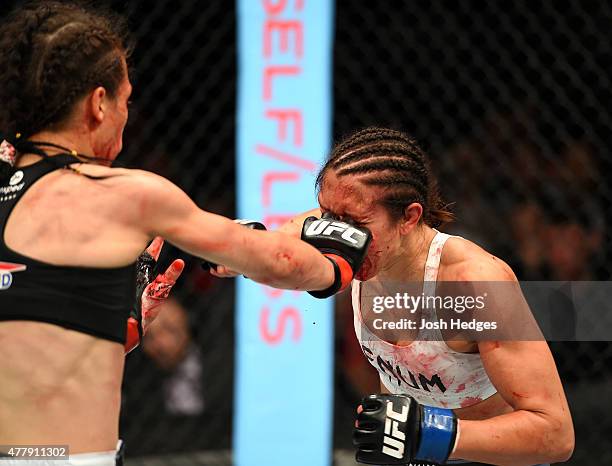 Joanna Jedrzejczyk of Poland punches Jessica Penne of the United States in their women's strawweight championship bout during the UFC Fight Night...