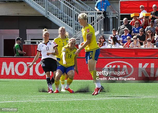 Anja Mittag of Germany scores the opening goal against Linda Sembrant, Amanda Ilestedt and Nilla Fischer of Sweden during the FIFA Women's World Cup...