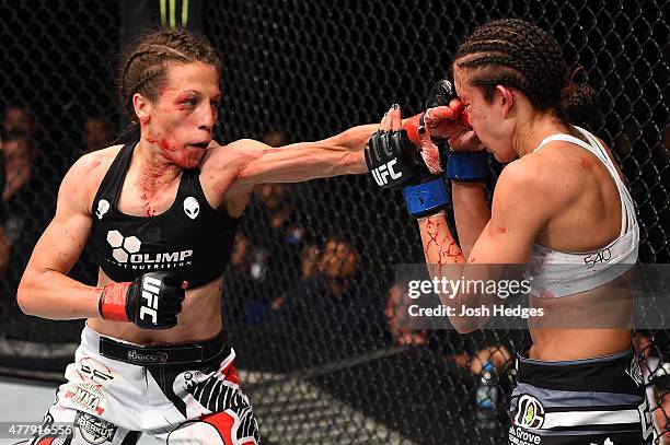 Joanna Jedrzejczyk of Poland punches Jessica Penne of the United States in their women's strawweight championship bout during the UFC Fight Night...