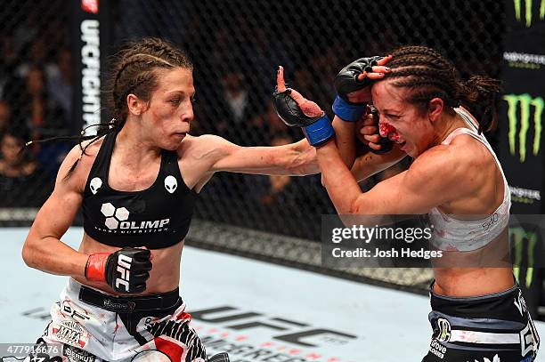 Joanna Jedrzejczyk of Poland punches Jessica Penne of the United States in their women's strawweight championship bout during the UFC Fight Night...