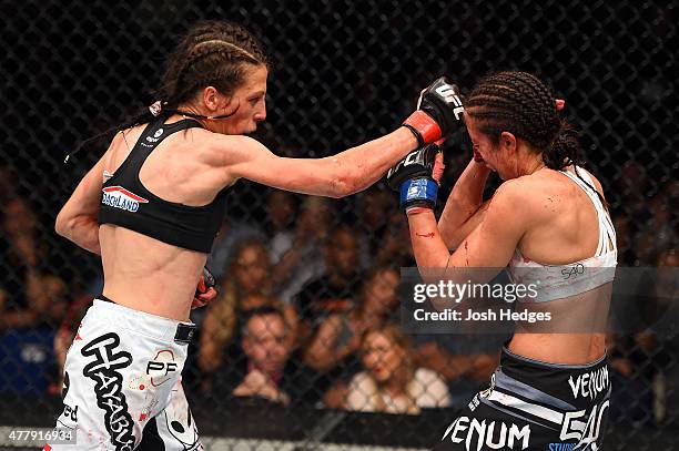 Joanna Jedrzejczyk of Poland punches Jessica Penne of the United States in their women's strawweight championship bout during the UFC Fight Night...