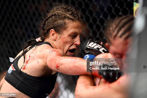 Joanna Jedrzejczyk of Poland punches Jessica Penne of the United States in their women's strawweight championship bout during the UFC Fight Night...