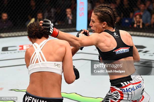 Joanna Jedrzejczyk of Poland punches Jessica Penne of the United States in their women's strawweight championship bout during the UFC Fight Night...