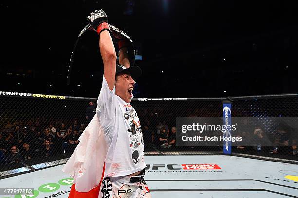 Women's strawweight champion Joanna Jedrzejczyk of Poland celebrates after defeating Jessica Penne of the United States in their women's strawweight...