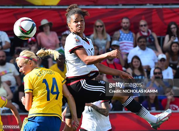 Germany's Celia Sasic heads the ball over Sweden's Amanda Ilestedt during their 2015 FIFA Women's World Cup football round of 16 match between Sweden...