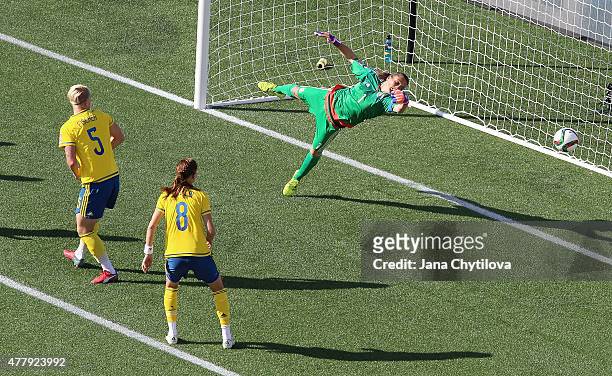 Nilla Fischer and Lotta Schelin of Sweden watch the ball get past the out stretched arm of Nadine Angerer of Germany for their lone goal during the...