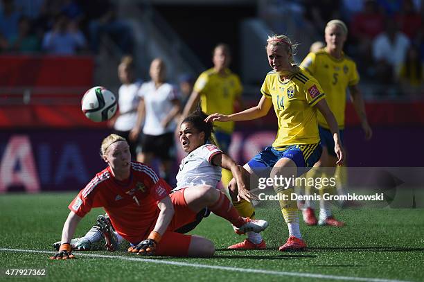 Celia Sasic of Germany misses a chance at goal under the pressure of Hedvig Lindahl and Amanda Ilestedt of Sweden during the FIFA Women's World Cup...