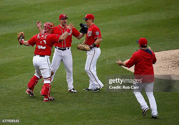 Starting pitcher Max Scherzer of the Washington Nationals celebrates with teammates Wilson Ramos, Tyler Moore and Dan Uggla after throwing a 6-0 no...