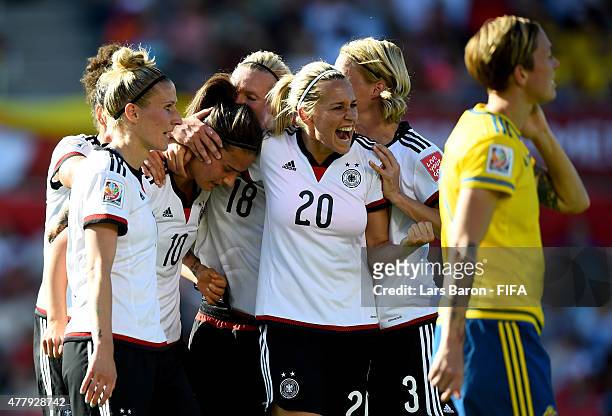Dzsenifer Marozsan of Germany celebrates with Lena Goessling of Germany and other team mates after scoring her teams fourth goal during the FIFA...