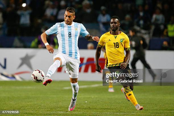 Roberto Pereyra of Argentina fights for the ball with Simon Dawkins of Jamaica during the 2015 Copa America Chile Group B match between Argentina and...