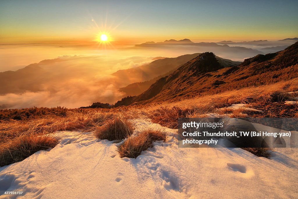 Golden sunset above the sea of clouds in winter