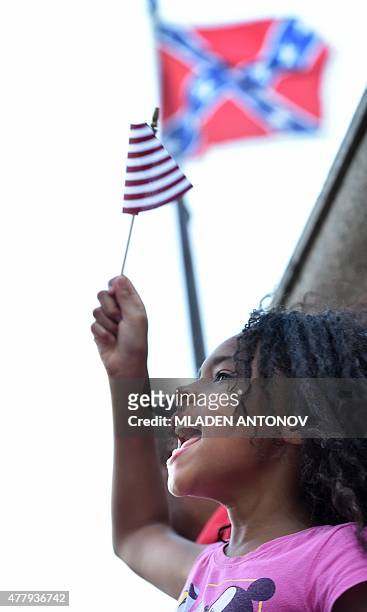 Girl shouts slogans as hundreds of people gather for a protest rally against the Confederate flag in Columbia, South Carolina on June 20, 2015. The...