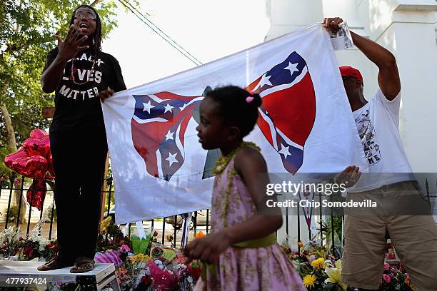 Anti-Confederate flag protesters demonstrate outside the historic Emanuel African Methodist Church where nine people were shot to death earlier this...