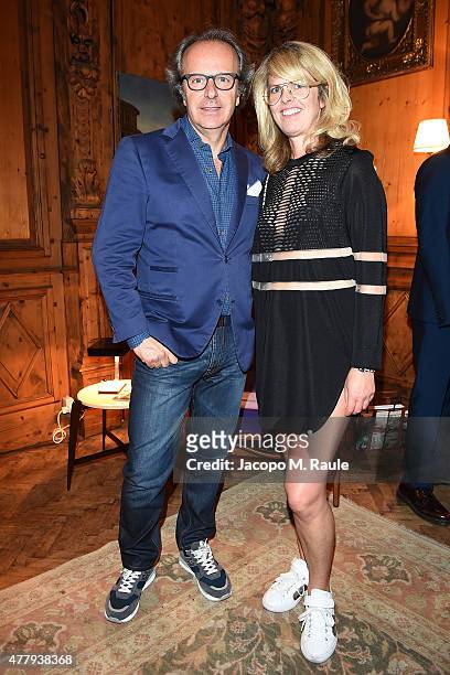 Andrea Della Valle and Madeline Weeks attend GQ Party for Jim Moore during Milan Menswear Fashion Week Spring/Summer 2016 at Casa Degli Atellani on...