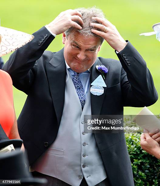 Hugh Bonneville ruffles his hair as he attends day 5 of Royal Ascot at Ascot Racecourse on June 20, 2015 in Ascot, England.