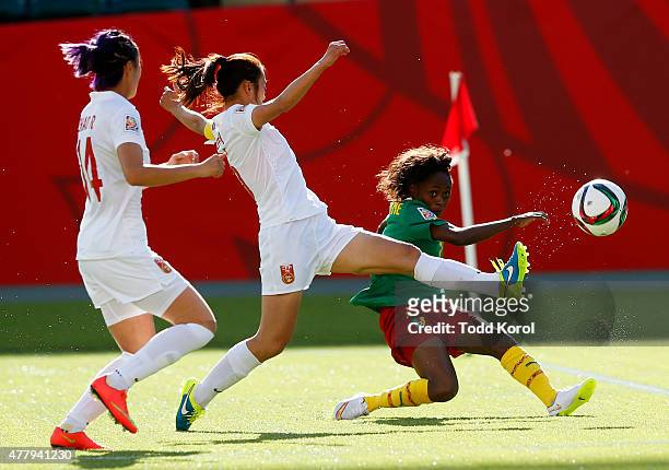 Wu Haiyan and Zhao Rong of China try to block the shot of Gabrielle Onguene of Cameroon during the FIFA Women's World Cup Canada Round 16 match...