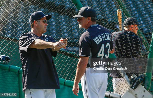 Newly hired hitting coach Edgar Martinez of the Seattle Mariners talks with outfield coach Andy Van Slyke prior to the game against the Houston...