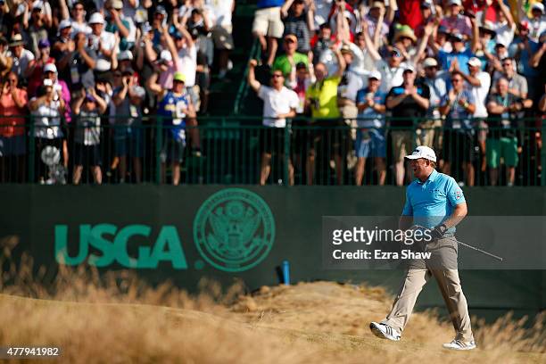 Holmes of the United States celebrates after holing out for eagle on the 16th hole during the third round of the 115th U.S. Open Championship at...