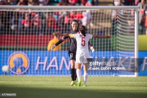 China's goalkeeper Wang Fei and teammate Wu Haiyan celebrate their 1-0 victory over Cameroon in their FIFA Women's World Cup Round of 16 Match at...