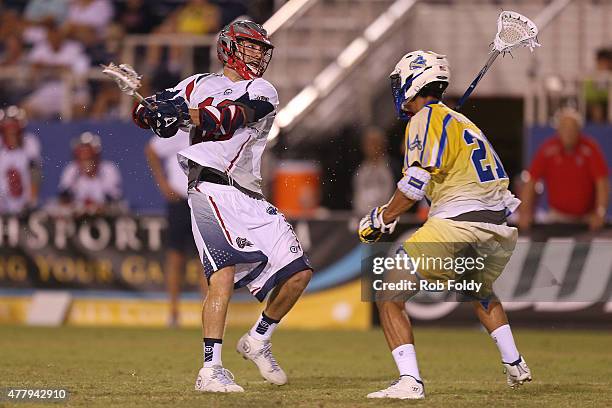 Brodie Merrill of the Boston Cannons shoots the ball while defended by Casey Ikeda of the Florida Launch during the fourth quarter of the game at FAU...