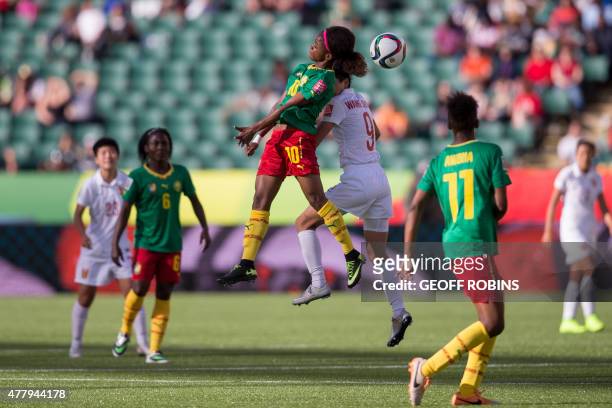 Cameroon's Jeannette Yango and China's Wang Shanshan vie for the header during their FIFA Women's World Cup Group of 16 Match at Commonwealth Stadium...