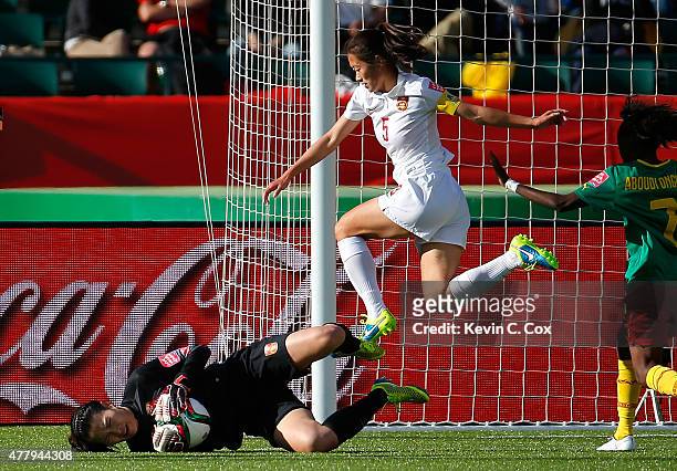 Goalkeeper Wang Fei of China PR saves a shot on goal against Cameroon during the FIFA Women's World Canada 2015 Round of 16 match between China PR...