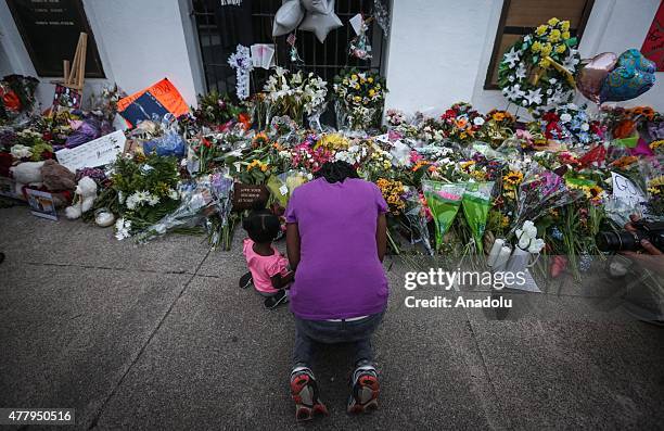 People gather in front of the Emanuel AME Church to pay respect to the nine shooting victims on June 20 in Charleston, South Carolina, USA.