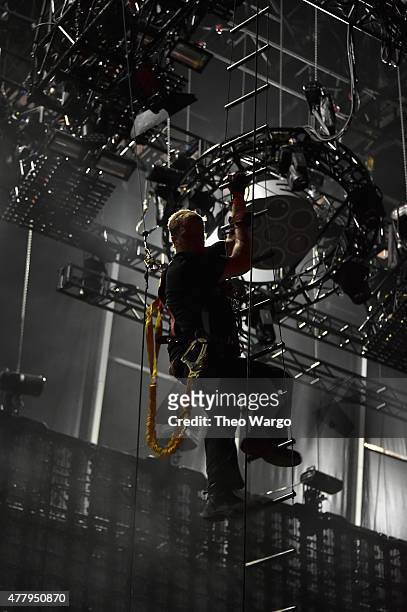 Lighting technician climbs down during inclement weather on day 3 of the Firefly Music Festival on June 20, 2015 in Dover, Delaware.