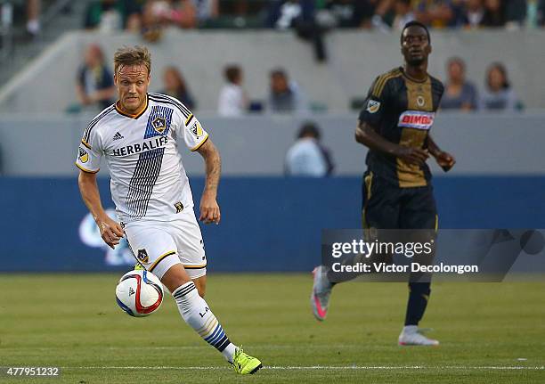 Mika Vayrynen of Los Angeles Galaxy paces the ball on the attack as C.J. Sapong of Philadelphia Union looks on in first half of the MLS match at...