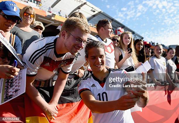 Dzsenifer Marozsan of Germany takes selfies with fans after winnning the FIFA Women's World Cup 2015 Round of 16 match between Germany and Sweden at...