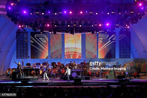 Musicians Jonathan Cain and Ross Valory, singer Arnel Pineda, and musician Neal Schon of Journey perform onstage during Hollywood Bowl Opening Night...
