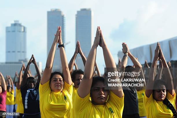 Yoga enthusiasts perform yoga during International Day of Yoga in Colombo on June 21 in a yoga session to mark the first International Yoga Day. AFP...