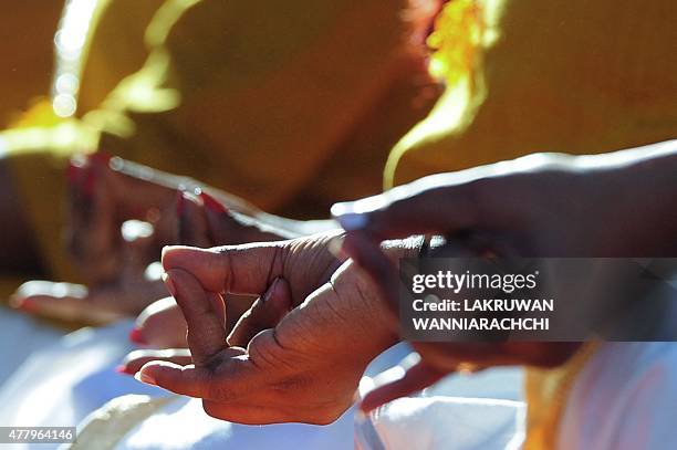 Yoga enthusiasts perform yoga during International Day of Yoga in Colombo on June 21 in a yoga session to mark the first International Yoga Day. AFP...