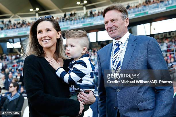 Corey Enright's wife Renee with son Boh look on with Sam Newman before the 2015 AFL round twelve match between the Geelong Cats and the Melbourne...
