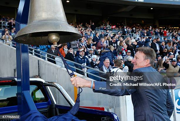 Sam Newman rings the bell as Corey Enright of the Cats runs onto the field for his 300th match during the 2015 AFL round twelve match between the...