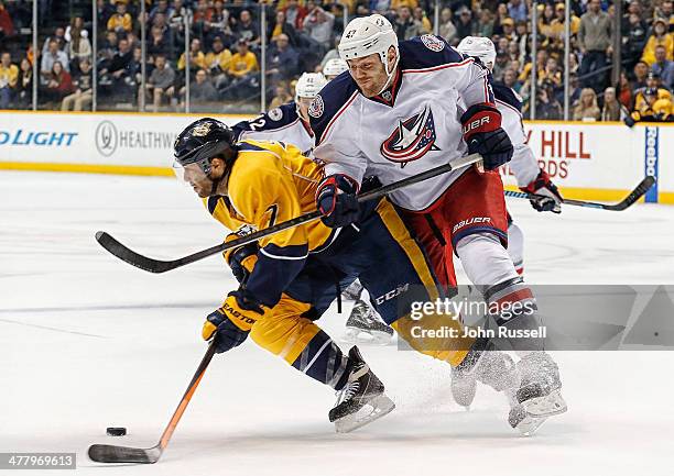 Dalton Prout of the Columbus Blue Jackets battles against Matt Cullen of the Nashville Predators at Bridgestone Arena on March 8, 2014 in Nashville,...