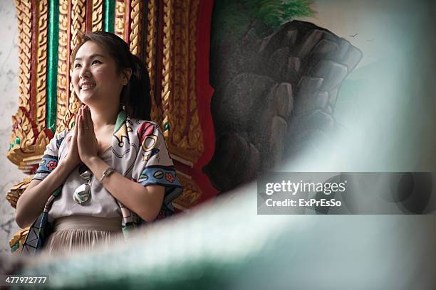 a asian woman prays at thai temple - puket fotografías e imágenes de stock