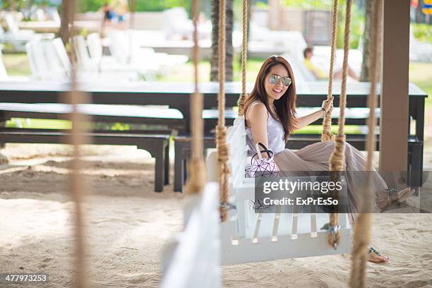 young woman on swing - puket fotografías e imágenes de stock