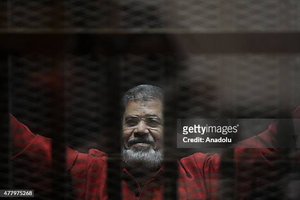 Former Egyptian President Mohamed Morsi, wearing a red uniform after Cairo Criminal Court on Tuesday sentenced him to death over a prison break in...